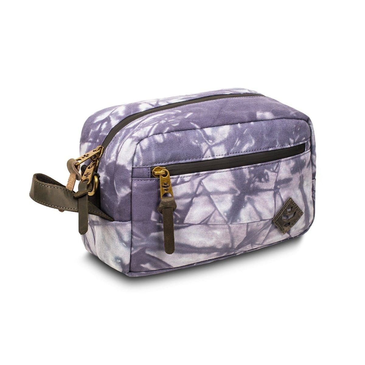 A slightly angled view of The Stowaway - Smell Proof Toiletry Kit, featuring a patterned purple exterior and leather zipper pull.