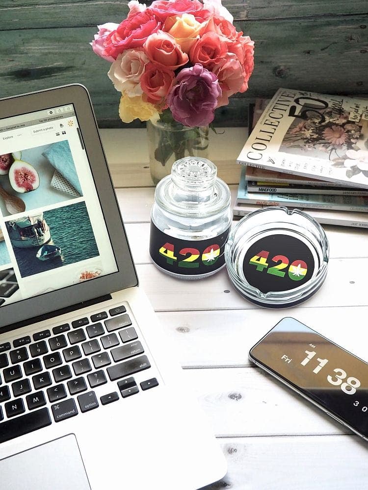 Overhead shot featuring the 420 DESIGN Ashtray set with Stash jar alongside an open laptop and stacked magazines on a light wood surface.