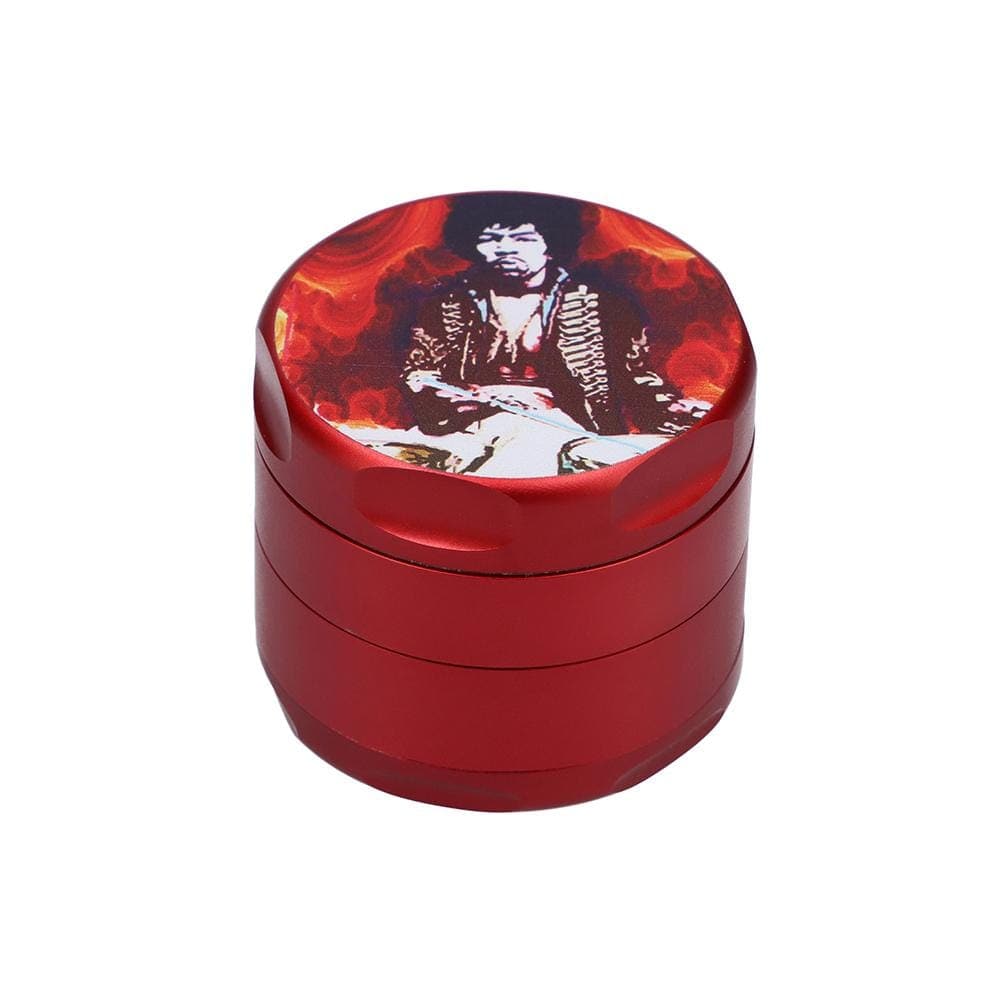 A close-up, angled view of the Jimi Hendrix Fire 55mm 4-Piece Grinder, showcasing its metallic red finish and circular design.