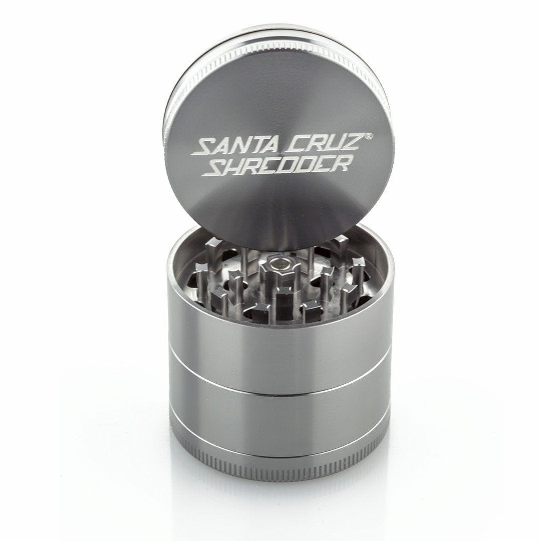 A close-up of the open Santa Cruz Shredder 4 Piece Medium Grinder, showing the metallic teeth inside its cylindrical form.