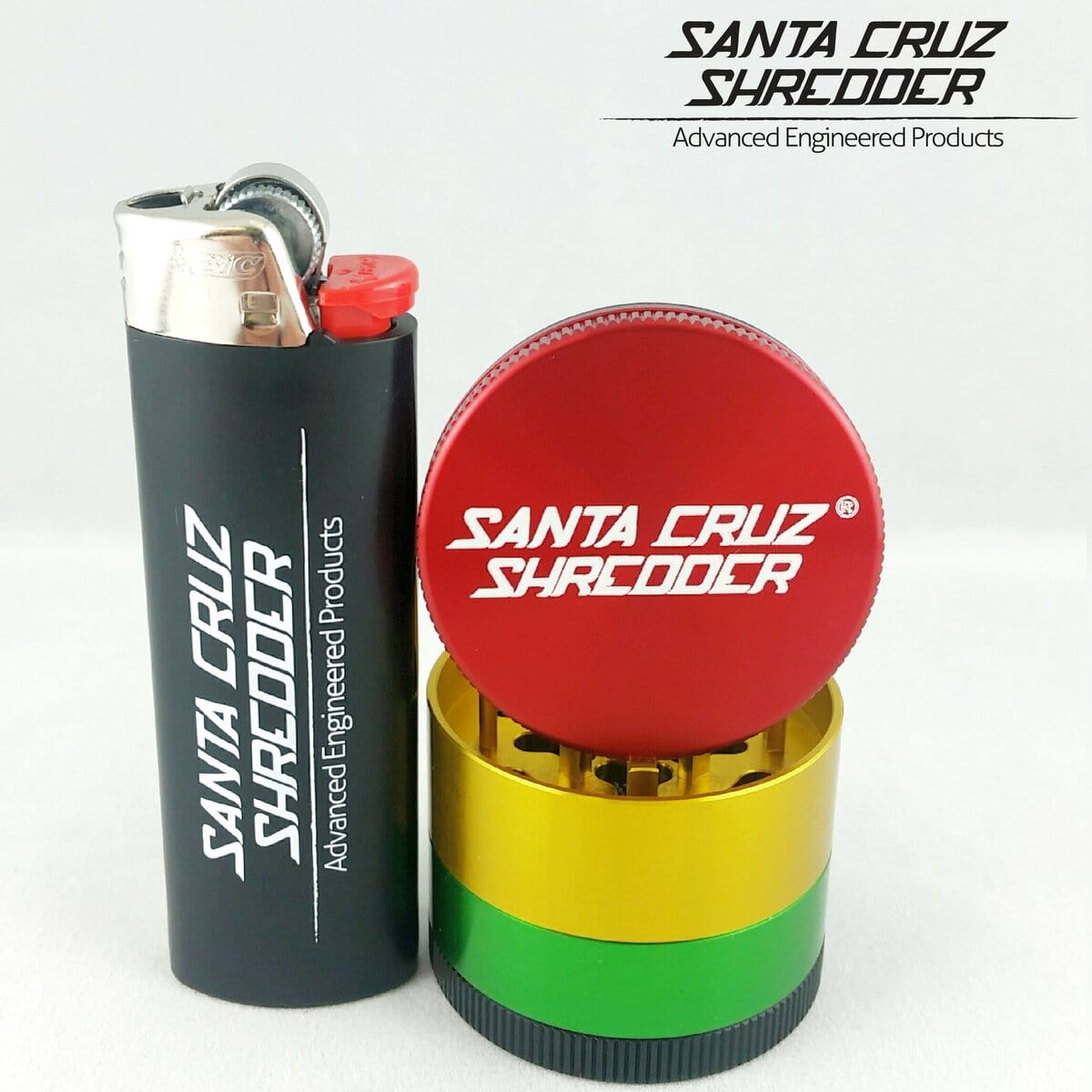 A close-up shot of the Santa Cruz Shredder 4 Piece Mini Grinder, showing its metallic finish next to a lighter.