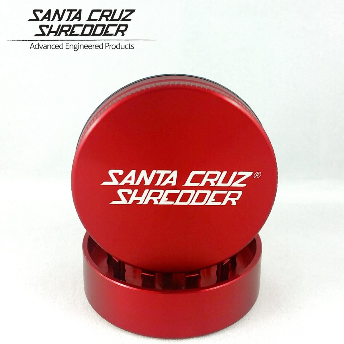 Front view of the Santa Cruz Shredder 2 Piece Medium Grinder, showcasing its metallic, multi-tiered construction.