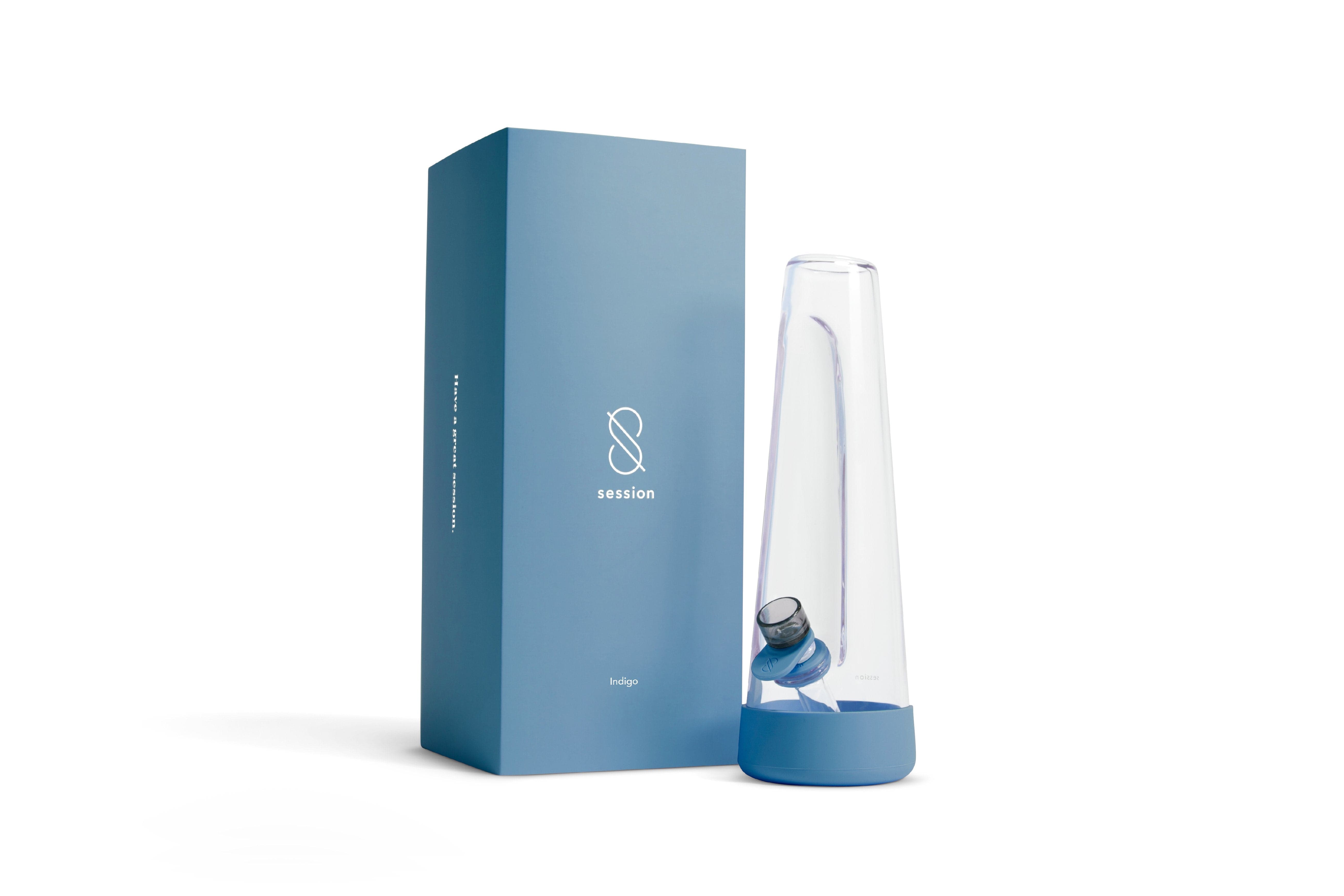 Right-side view of a clear glass cone next to its indigo box packaging for the Session Goods Modern Bong.