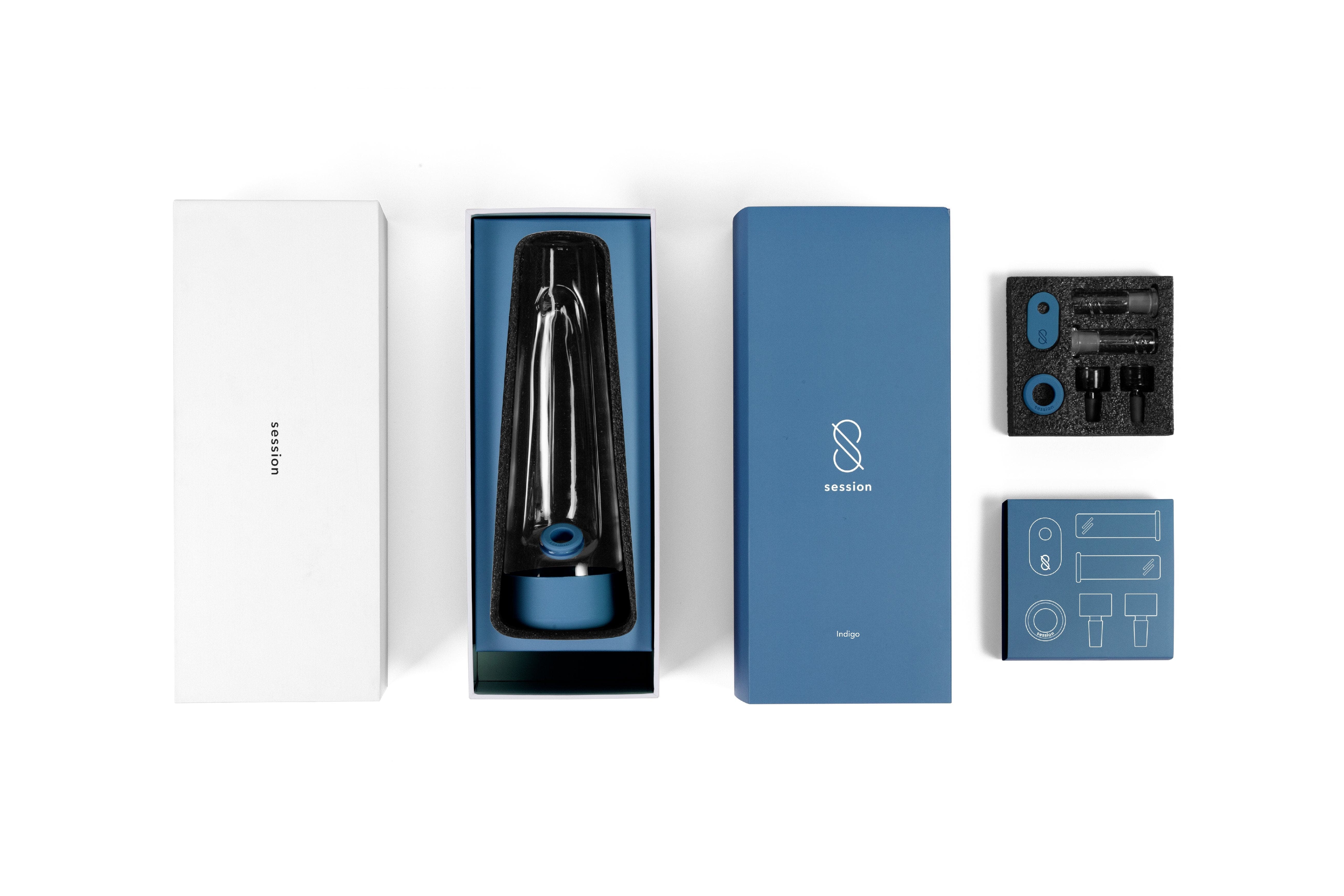 Top-down shot of the Session Goods Modern Bong in its indigo box with foam inserts and accessory tray.
