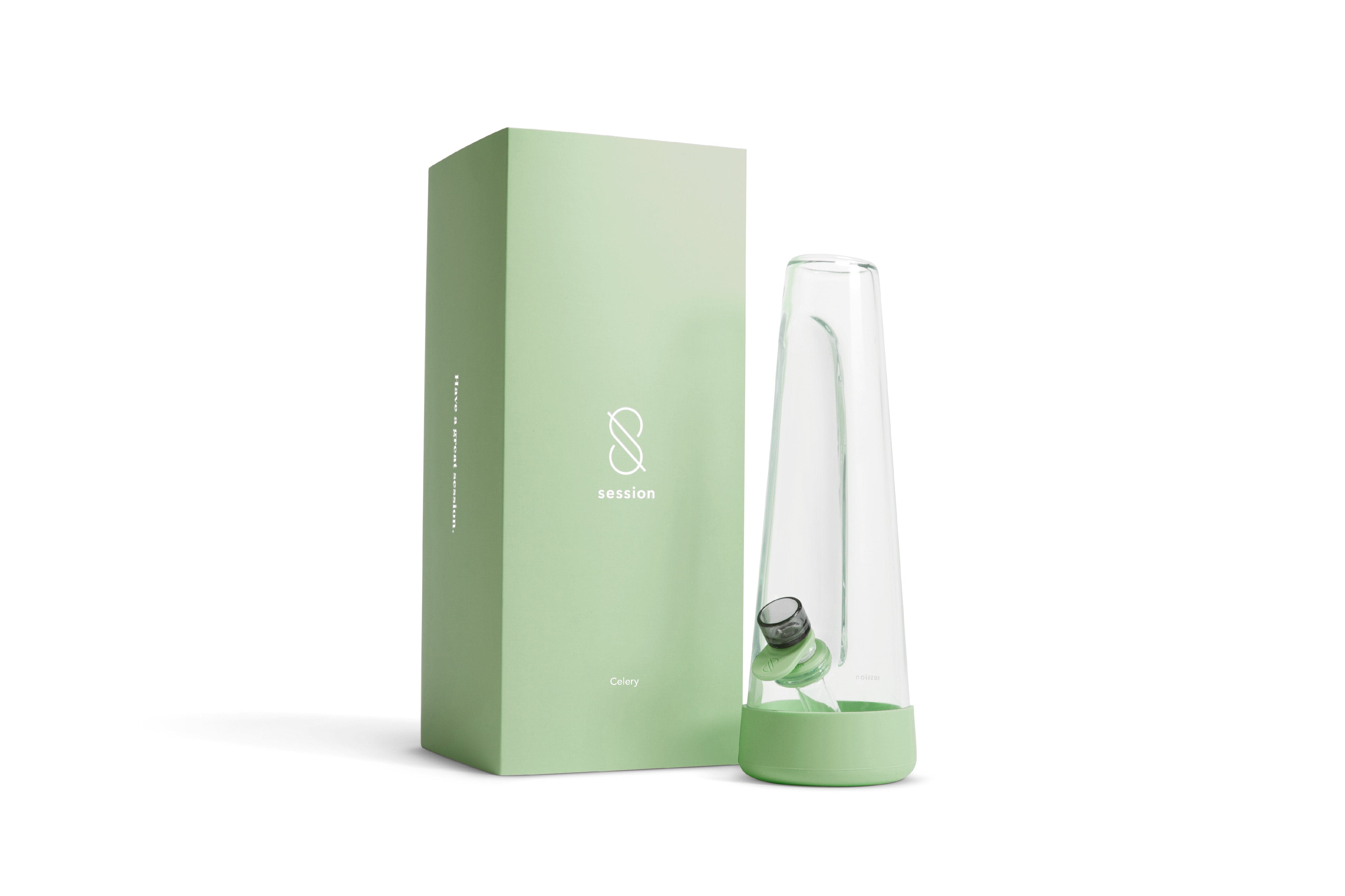 Right-side view of the clear glass Session Goods Modern Bong with a celery-green base and matching box behind it.