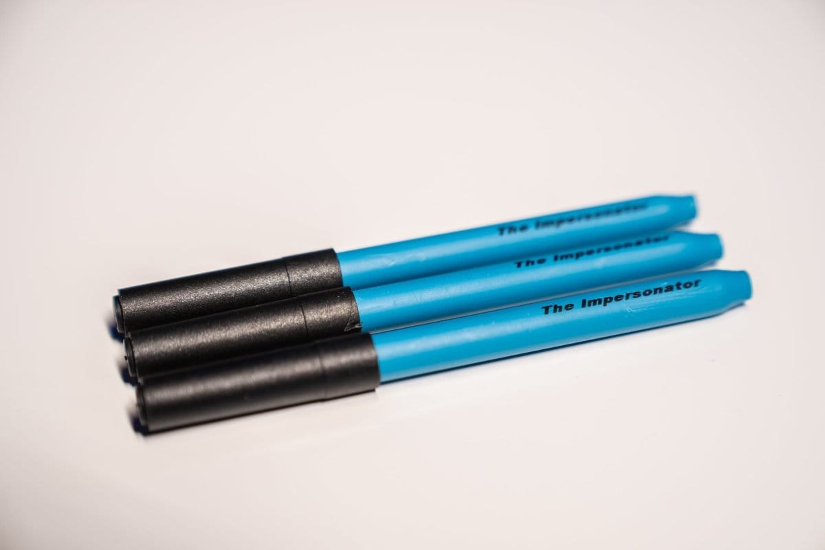 A studio shot of The Impersonator 3-Pack, featuring three black, cylindrical items arranged in a fan-like pattern against a plain white background.