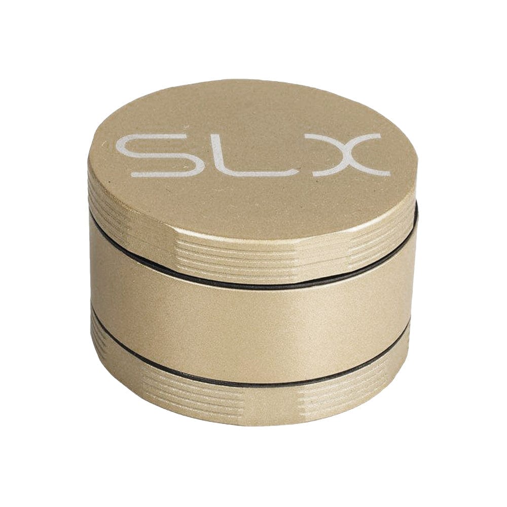 A close-up, angled view of the SLX Ceramic Coated Metal Grinder, showing its metallic finish and four-piece construction.
