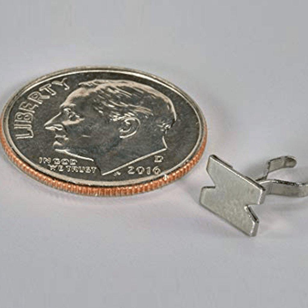 A close-up shot of the Smojo Screen positioned next to a coin, showing its metallic mesh construction.