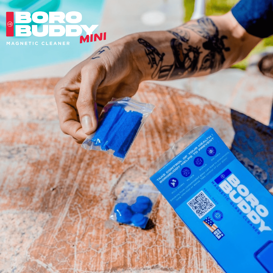 A close-up view of the BoroBuddy Mini Cleaning Pads stacked on a textured surface, showing their blue and white color scheme.