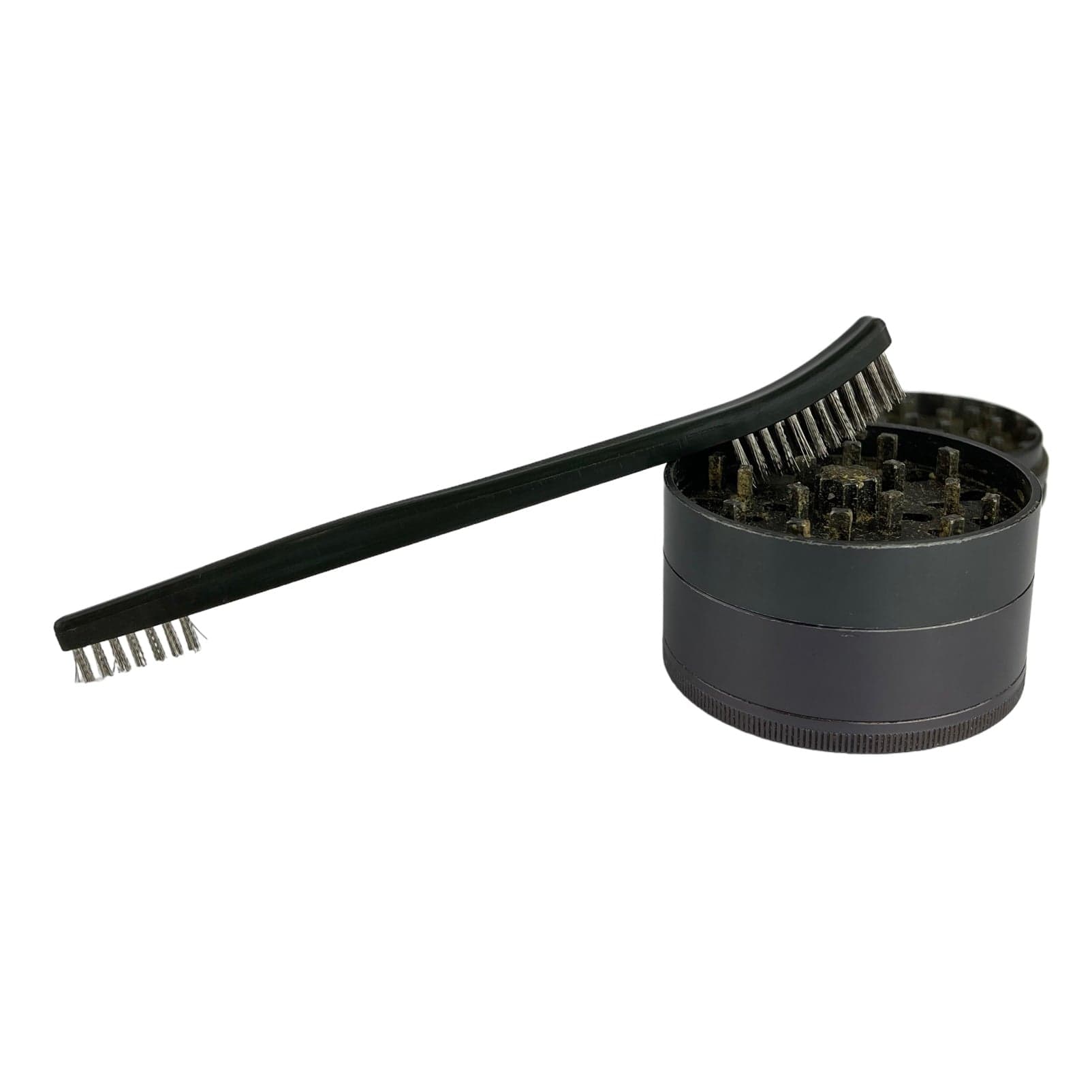 The Grinder Brush appears in a close-up shot, showcasing its dark bristles and cylindrical handle against a plain white background.