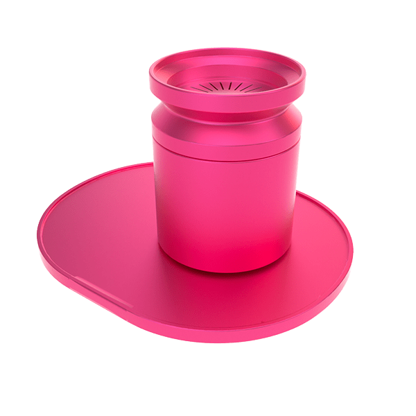 Angled top-down view of the bright pink Stundenglass Pink Infusion Chamber Assembly centered on its matching oval base, showing the ribbed inner chamber and matte finish