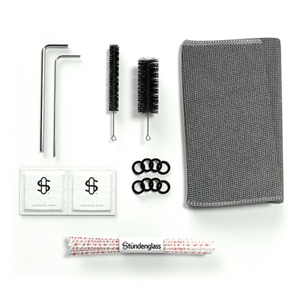A close-up of the Stündenglass Kompact Gravity Infuser accessories, showing cleaning tools against a white background.