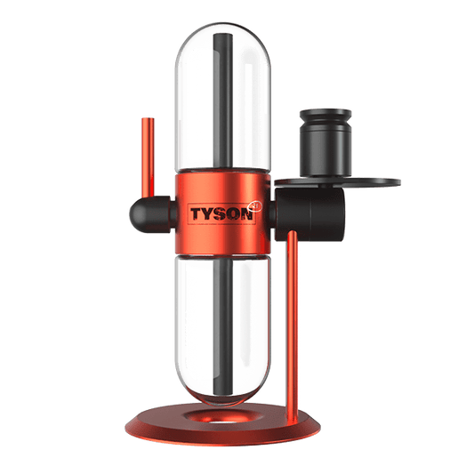 A front view of the Tyson 2.0 x StündenglassGravity Infuser with a clear glass body and red accents, set against a dark background.