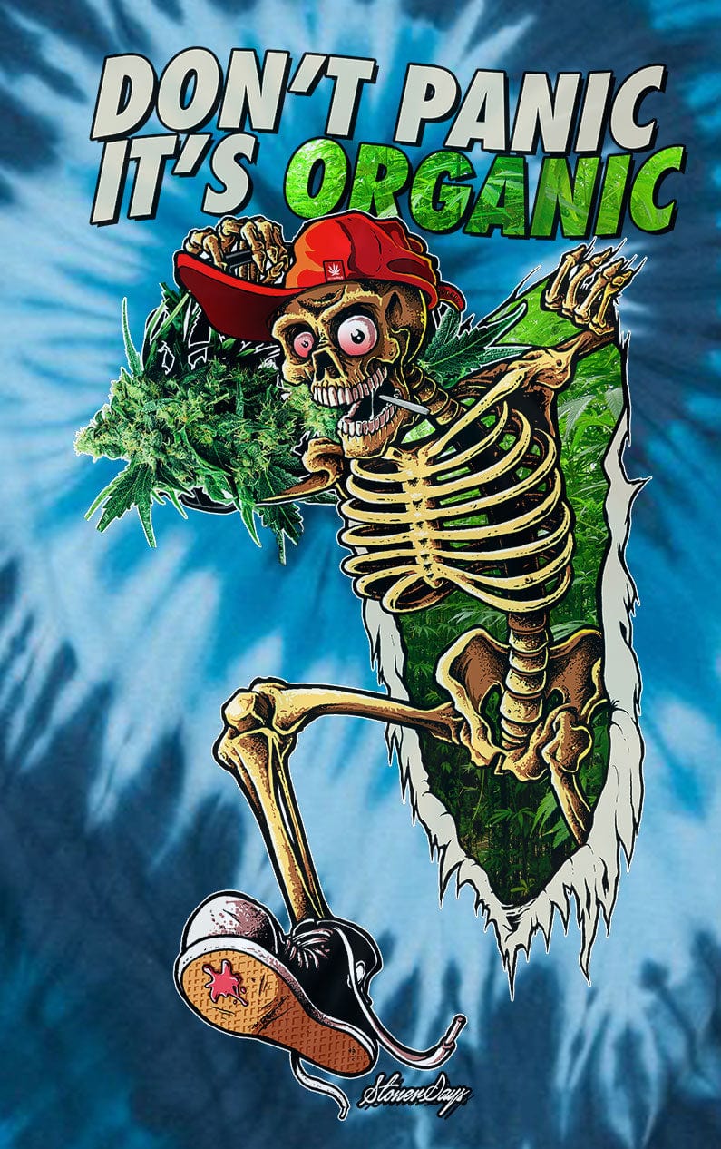 Front-facing graphic on a blue tie-dye background showing a grinning skeleton bursting through foliage while holding buds, featuring the Dont Panic Greens Blue Tie dye design.