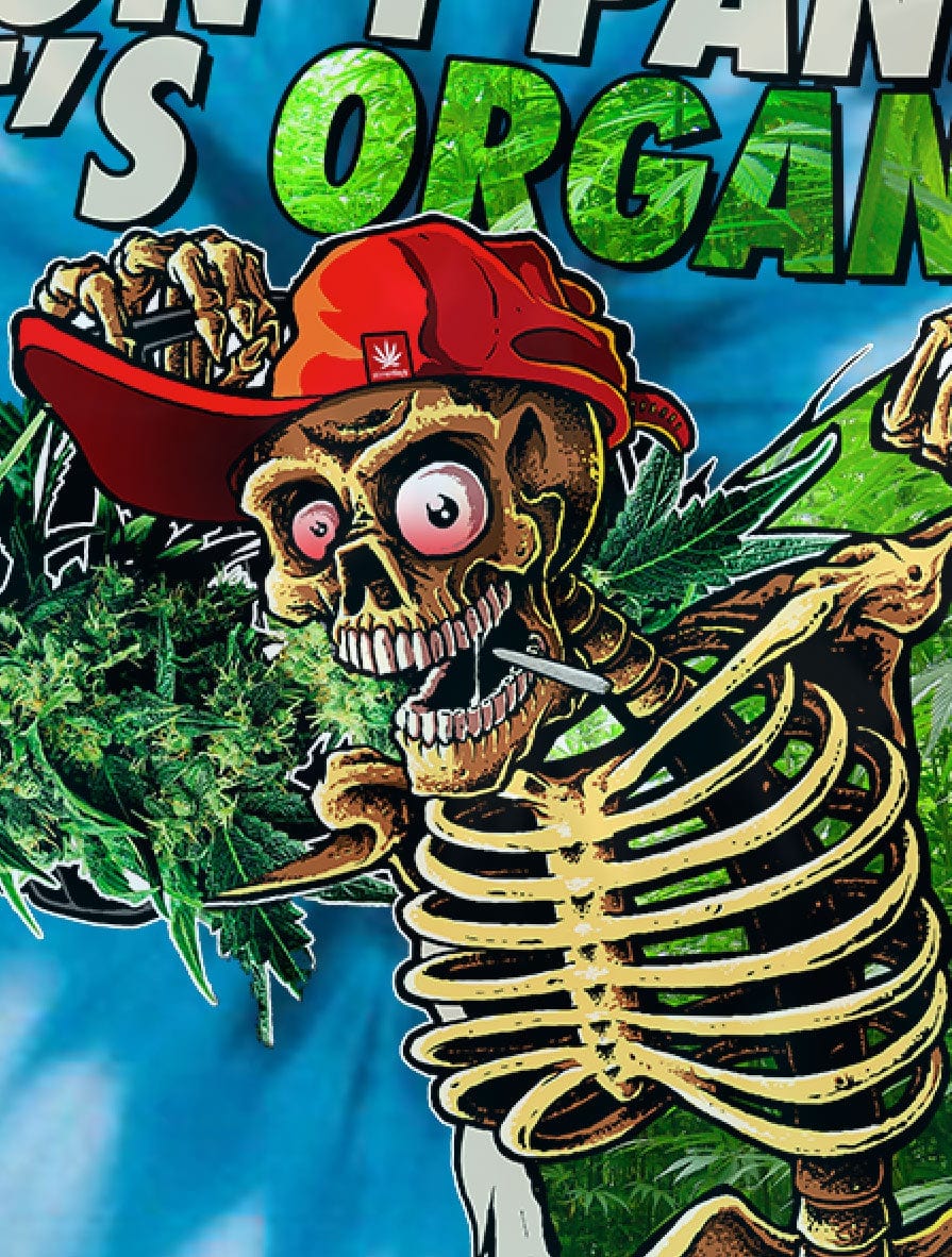 Close-up of a grinning skeleton wearing a red cap and holding a joint against a blue tie-dye background in the Dont Panic Greens Blue Tie dye design.