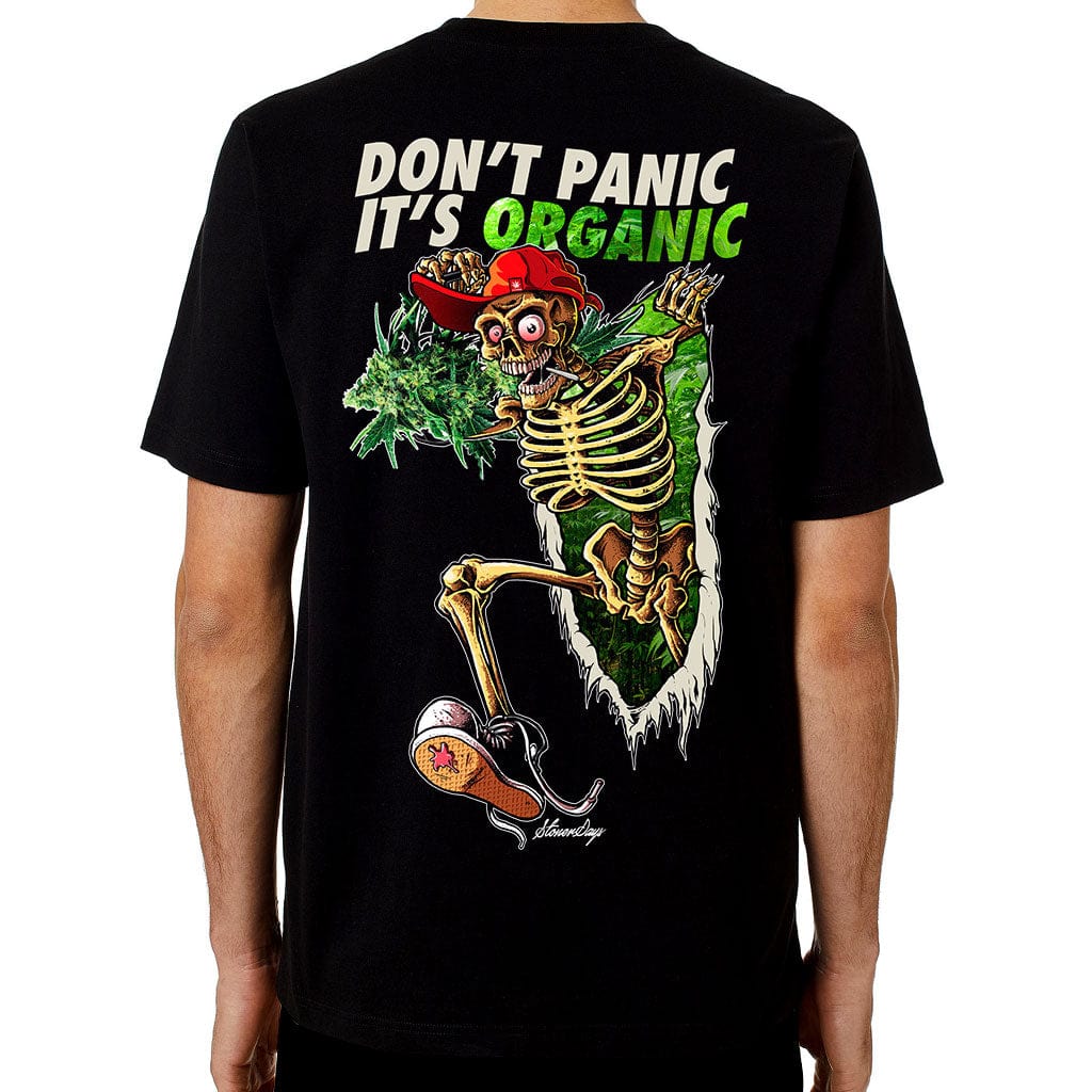 Front view of the Dont Panic Greens Tee, featuring a graphic of a skeleton bursting from lush green foliage.