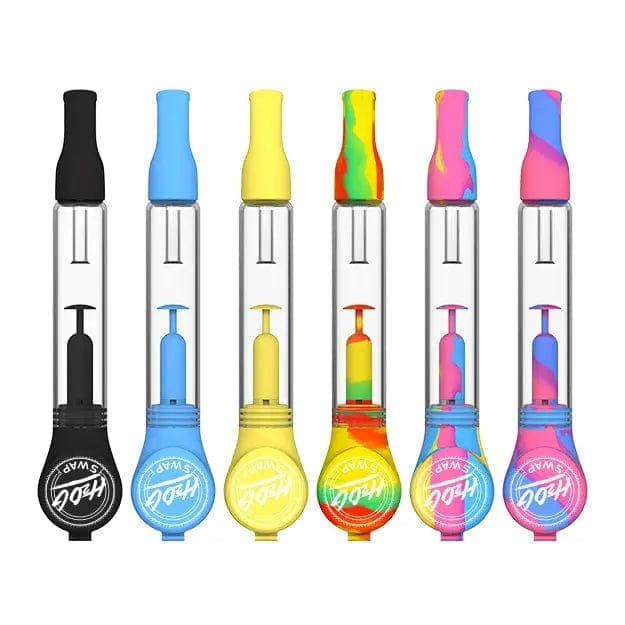 Row of six upright H20G SWAP Silicone and Glass Bong pieces photographed front-on against a white background, each showing clear glass tubes with colorful silicone mouthpieces and bases in aqua, black, yellow, tie-dye, and pink swirls.