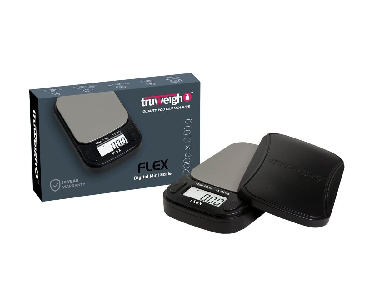 A close-up, angled view of the Truweigh Flex Mini Scale, displaying a digital readout on its sleek black surface.