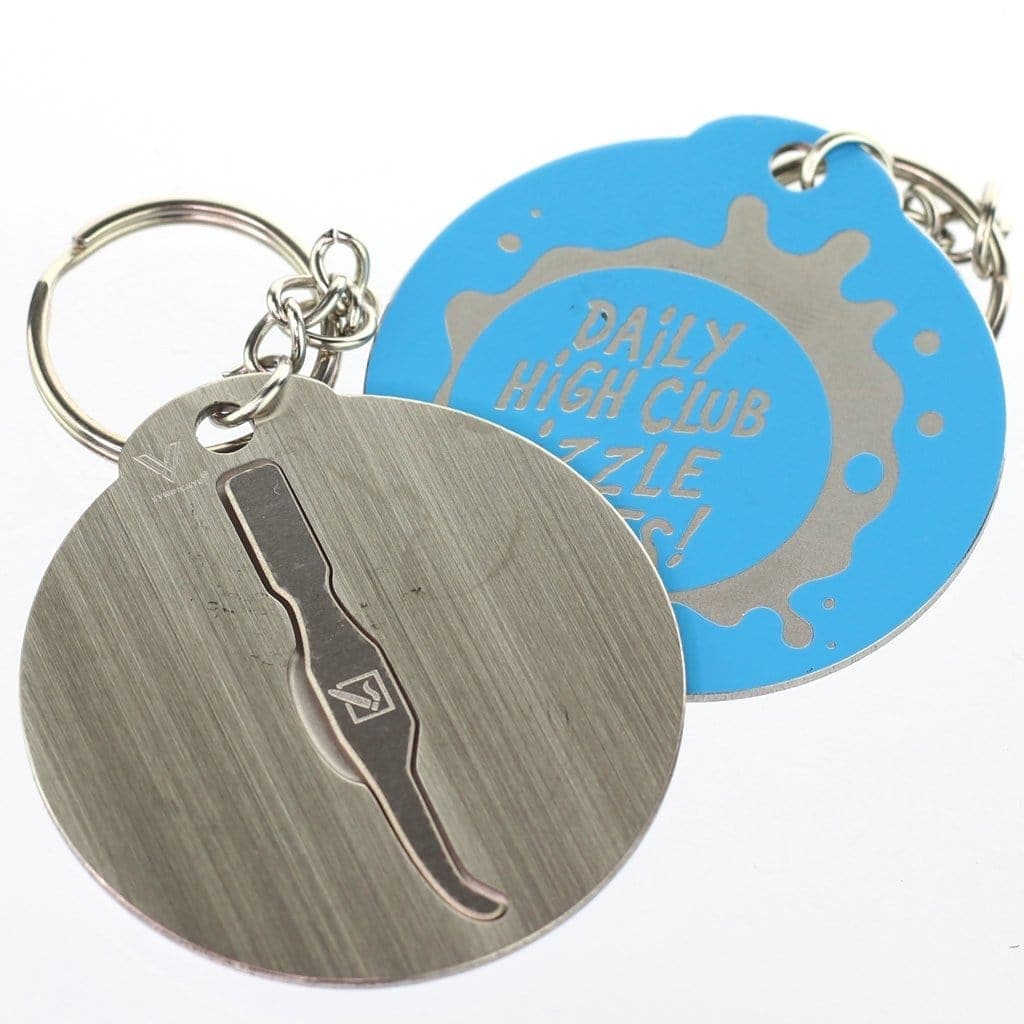 A close-up, angled view of the DHC Originals Keychain Dabber with a blue circular design and attached key ring.