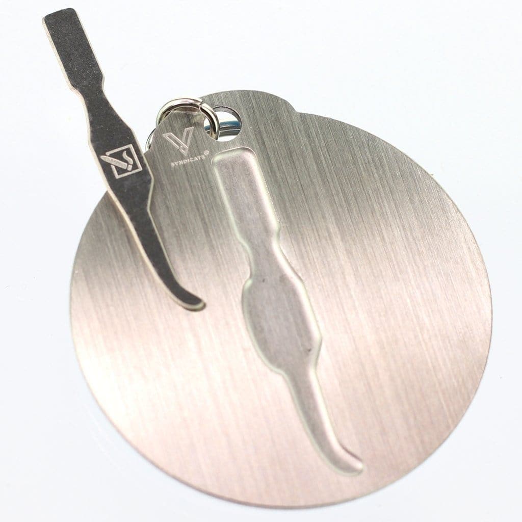 A close-up of the DHC Originals Keychain Dabber, showing the metallic tool attached to a keyring against a white background.