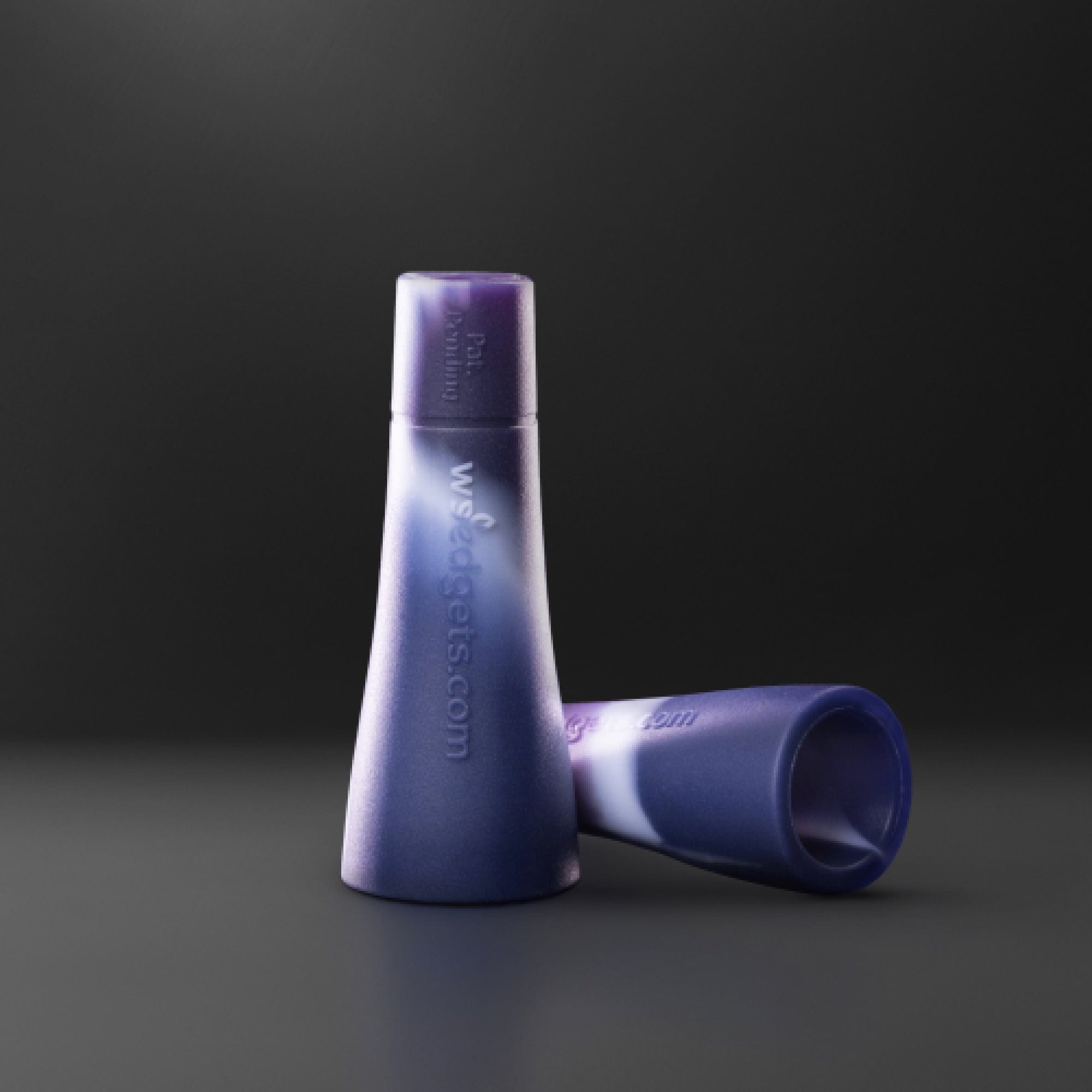 A slightly angled view of the Tic-Toke Filter Tips - MEDIUM set of 2| showcasing their cylindrical shape against a dark backdrop.