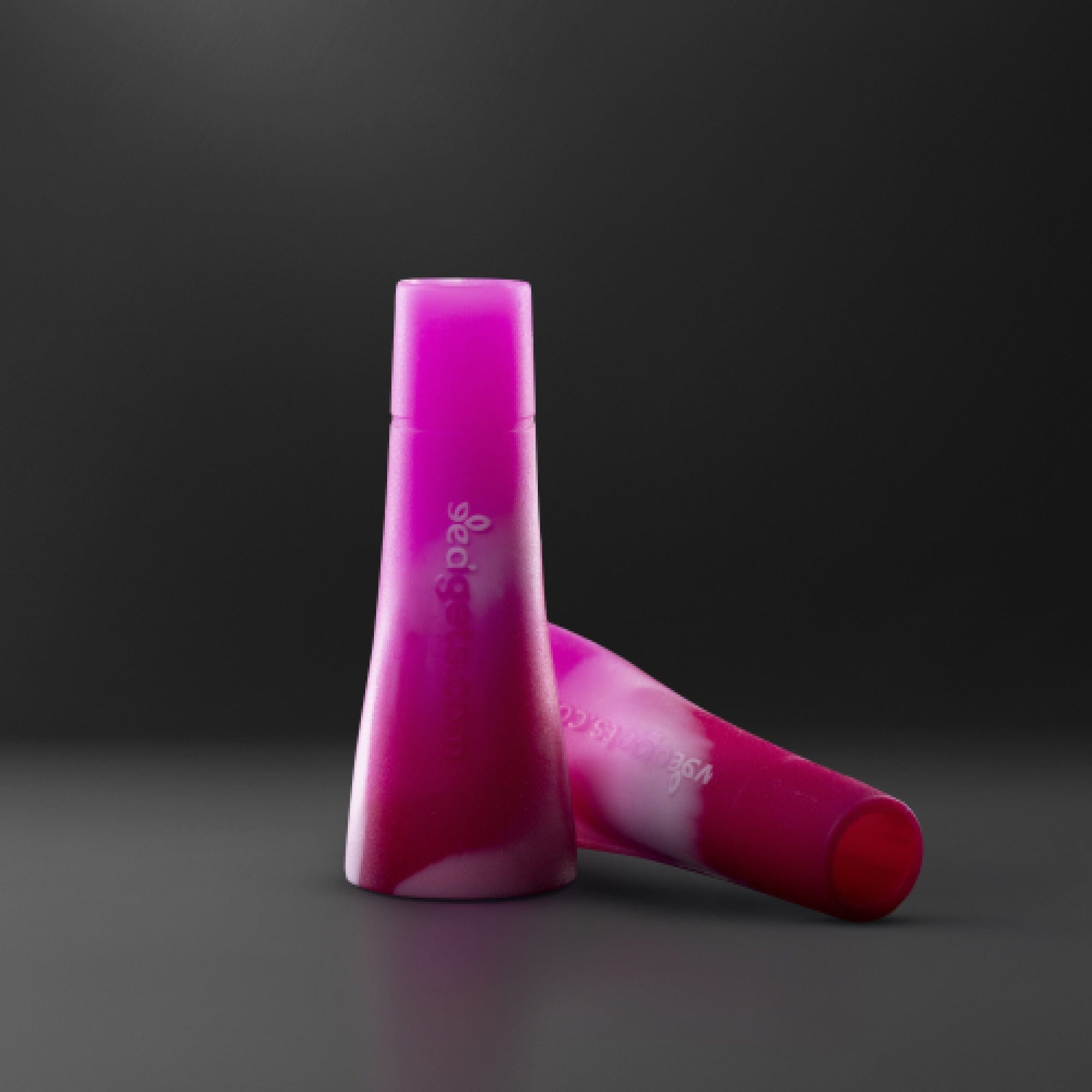 A close-up, angled view of the Tic-Toke Filter Tips - MEDIUM set of 2| showcasing their simple, cylindrical shape against a dark background.
