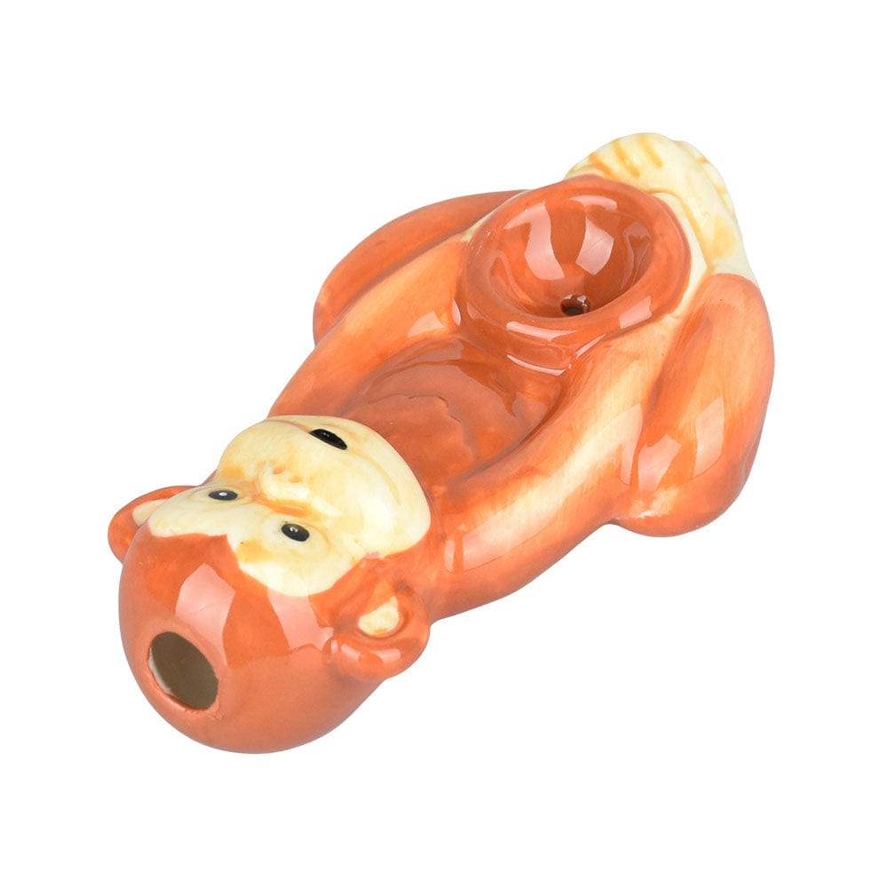 A side view of the Wacky Bowlz Monkey Ceramic Hand Pipe, sculpted as a playful monkey head in a glossy ceramic finish.