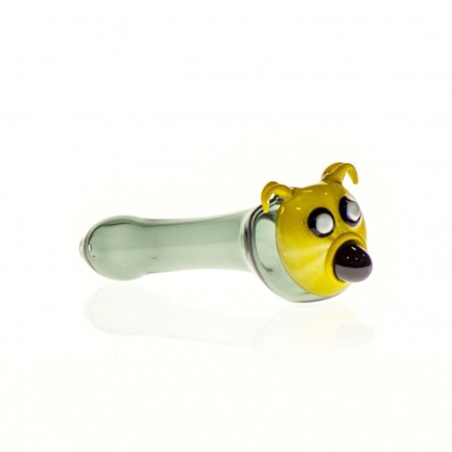 A side view of the Yellow Dog Spoon Pipe, showing the ceramic dog head and smooth glass body.