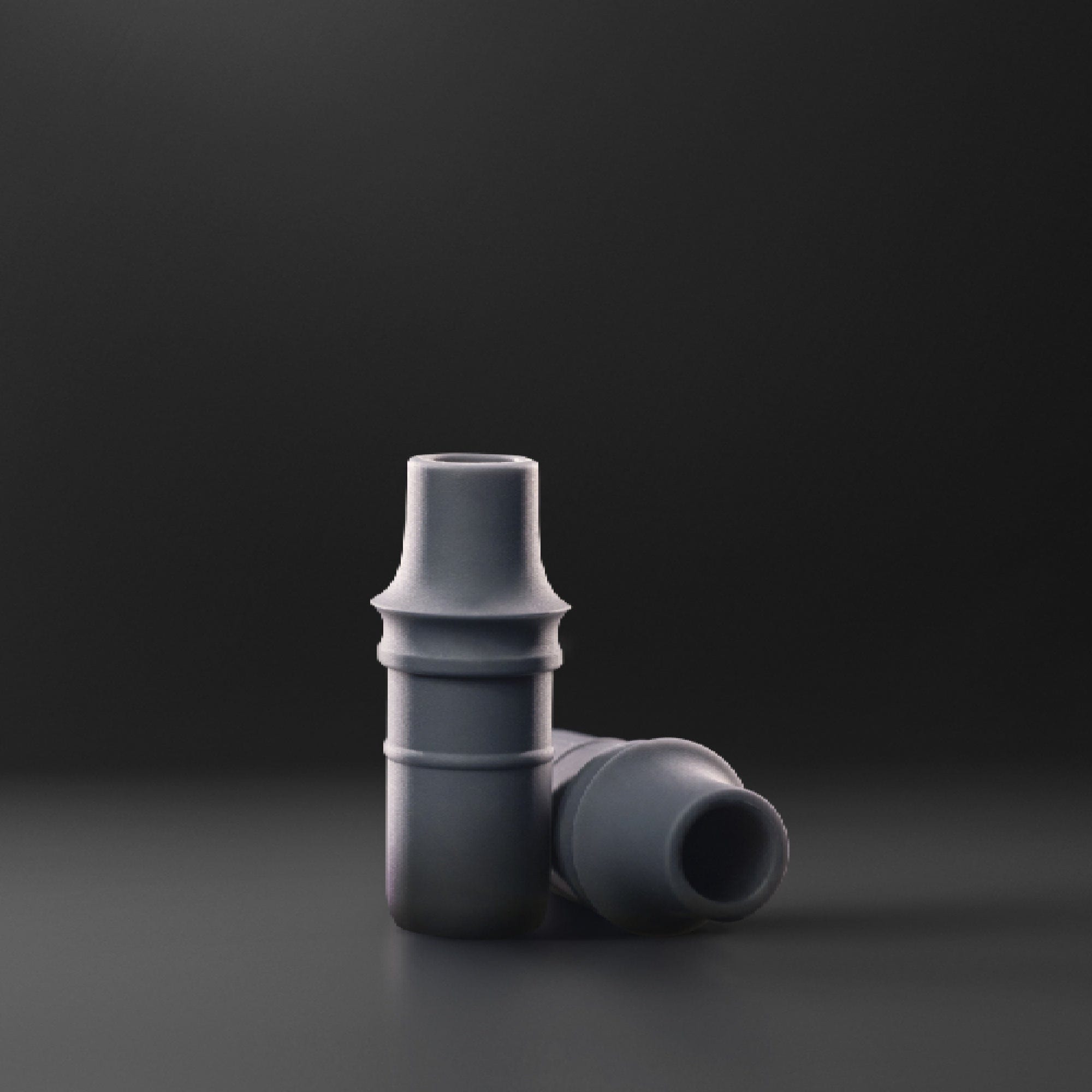 A close-up, angled view of the Filter Tip Inserts - Doob Tube add-ons, showcasing their small, cylindrical shape on a dark background.